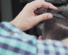 Taglio di capelli con pettine in un salone di bellezza.